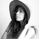 meesh in black and white wearing a hat